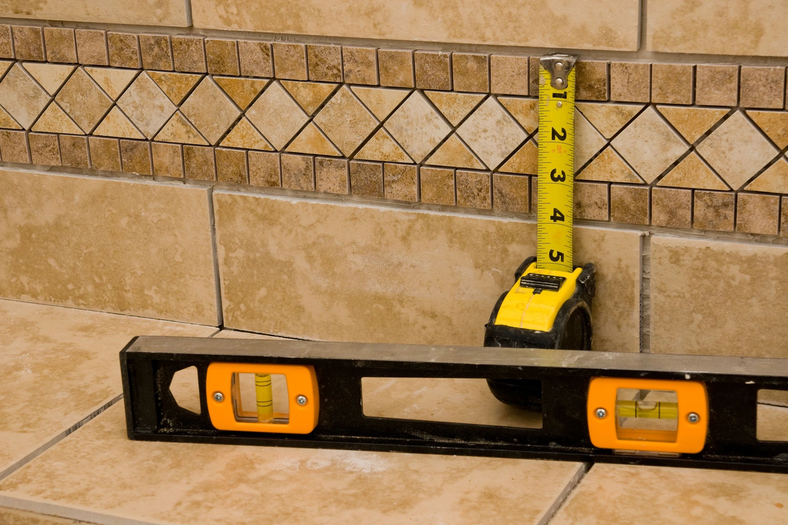 measuring tape and level on tile - Contract Interiors, IN