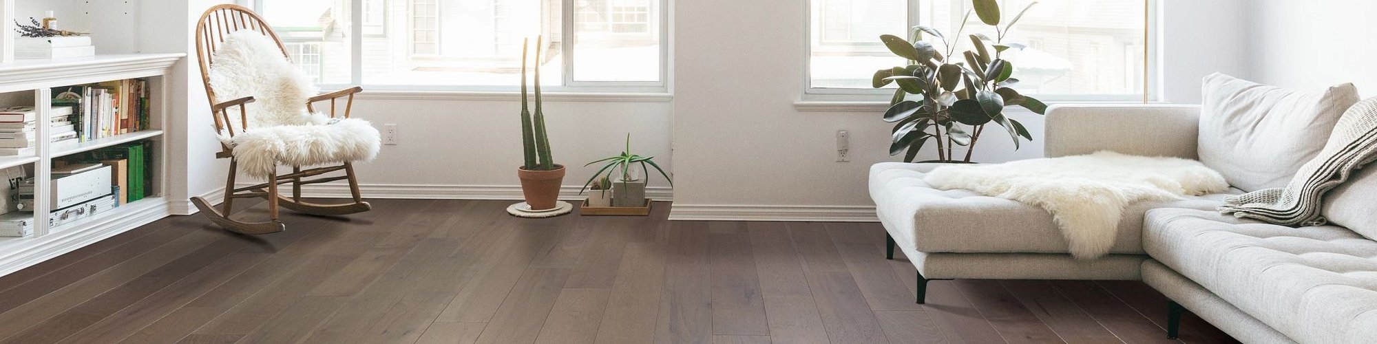 light grey L couch on dark hardwood flooring - Contract Interiors in Fort Wayne